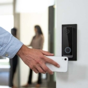 A man uses his phone to access an office with a smart lock system.