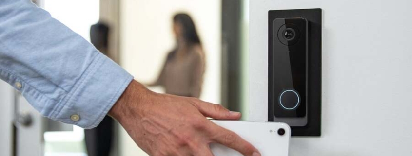A man uses his phone to access an office with a smart lock system.