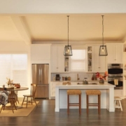 A luxury kitchen on a fall afternoon with Lutron motorized shades on the windows.