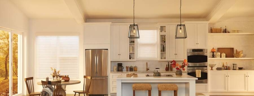 A luxury kitchen on a fall afternoon with Lutron motorized shades on the windows.