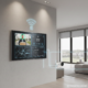 Smart home security and automation control panel managing surveillance cameras, temperature settings, lighting, and connected devices in a modern home interior.